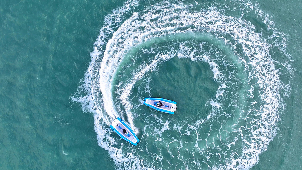 Two Pulse 63 RIB's driving in a circle, photo taken from a drone looking from above.